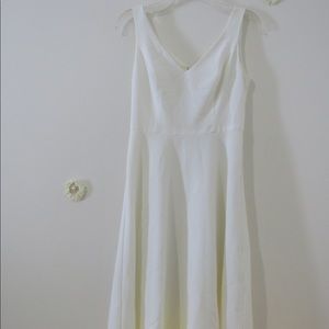Knee length white dress.